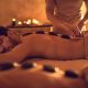 Young man relaxing at the spa with his eyes closed while receiving lastone therapy.